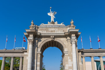 Fototapeta premium Princes Gates against blue sky at Exhibition Place in Toronto, Canada, in 2026. Princes Gates serves as a monumental gateway and the eastern entrance to the Canadian National Exhibition (CNE) grounds.