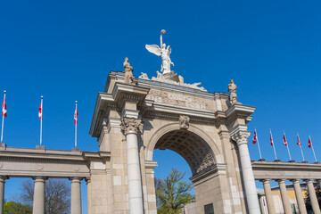 Fototapeta premium Princes Gates against blue sky at Exhibition Place in Toronto, Canada, in 2026. Princes Gates serves as a monumental gateway and the eastern entrance to the Canadian National Exhibition (CNE) grounds.