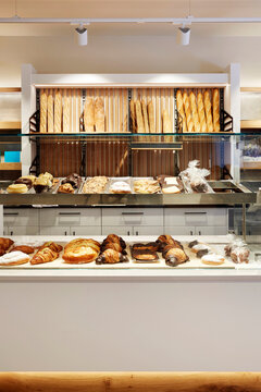 Fresh bread and pastry display in modern bakery counter