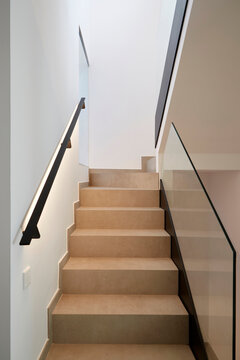 Modern staircase interior with glass railing and clean lines