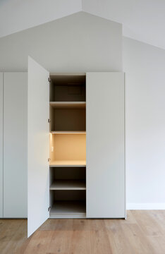 Minimal interior wardrobe with open doors and shelving