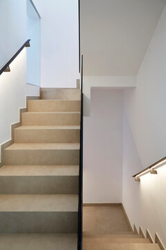 Modern home stairwell with stone step and clean wall