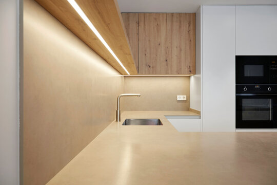 Modern minimalist kitchen interior with wood and LED light