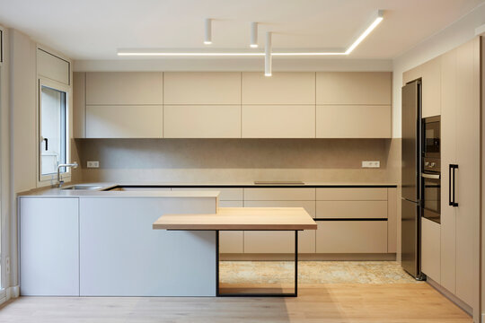 Modern minimalist kitchen interior with island and lighting