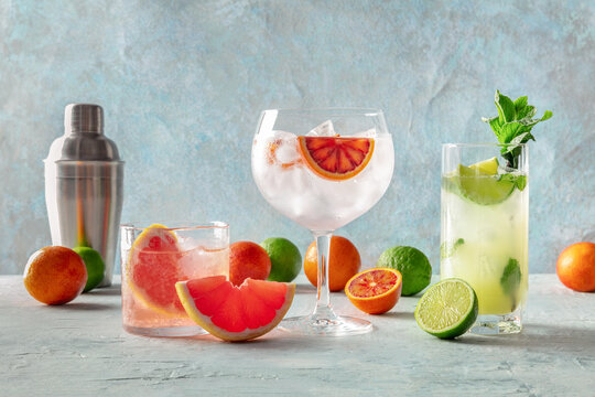 Refreshing summer cocktails with citrus fruits on blue