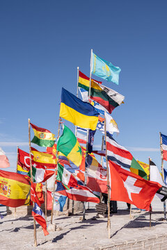 Colorful flags at Uyuni Salt Flats under blue sky