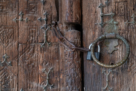 Ancient carved wooden door with padlock in Khiva, Uzbekistan