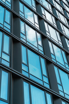 Modern glass building facade with reflective windows