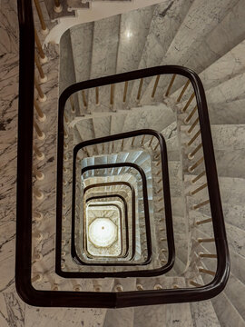 Top view of marble spiral staircase with geometric rail