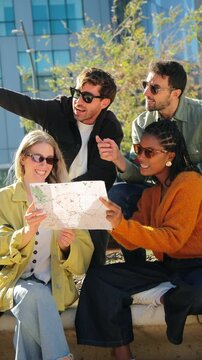 A cheerful group of friends gathers around a map, eagerly discussing their next destination while enjoying their adventurous outing together. They appear engaged and excited about their plans.