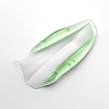Green cosmetic gel smear on white background
