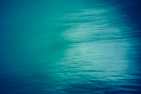 Abstract teal motion blur background with soft light