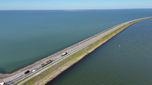 Aerial view of the houtribdijk causeway traffic crossing the markermeer lake in the netherlands