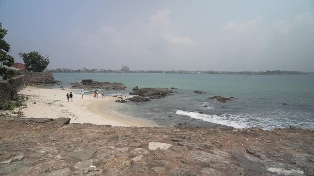 Elevated view from city wall of Hidden Beach, ocean and Galle Fort on a sunny day, Galle Dutch Fort, Galle, Southern Province, Sri Lanka, Asia
