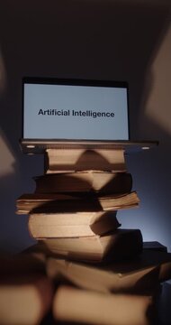 Artificial Intelligence learning concept. Laptop with integrated AI system over stack of old books. Flashing light behind. Contemporary education idea.  