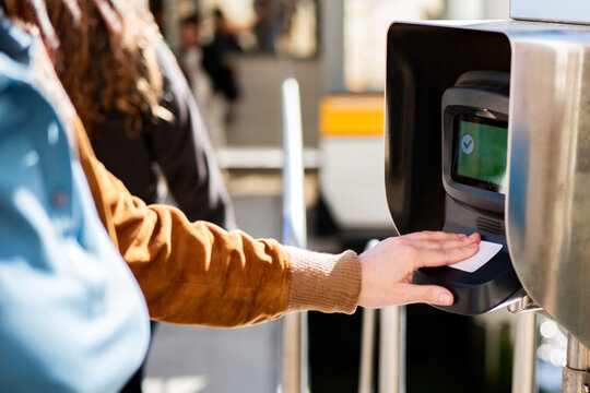 Commuter using contactless ticket validation machine in Venice