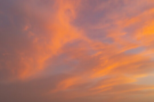 Soft orange sunset cloudscape with pastel sky background