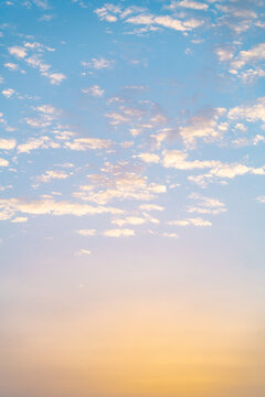 Soft pastel sky with scattered cloud at sunrise background