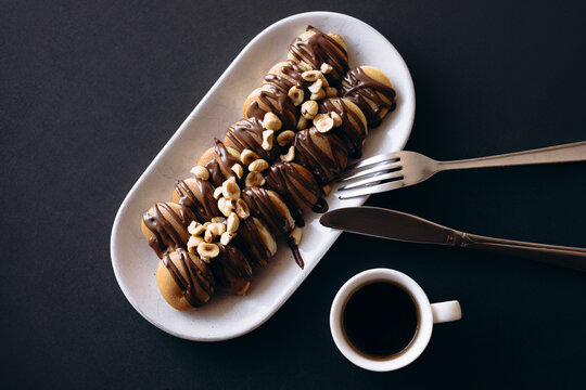 Mini pancakes with chocolate and hazelnuts with coffee