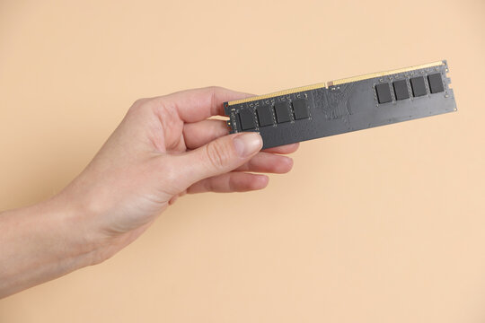 Woman with SD RAM on beige background, closeup