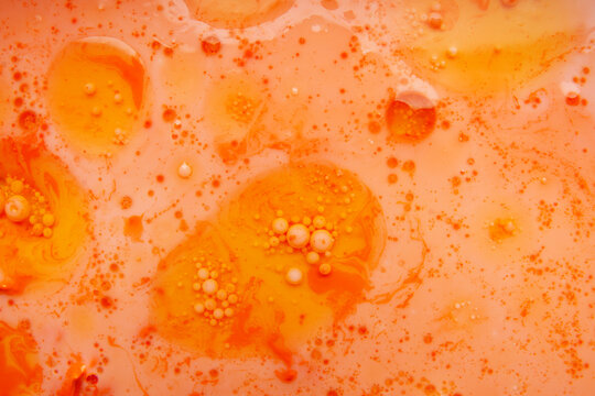Abstract orange oil background with floating bubble spheres
