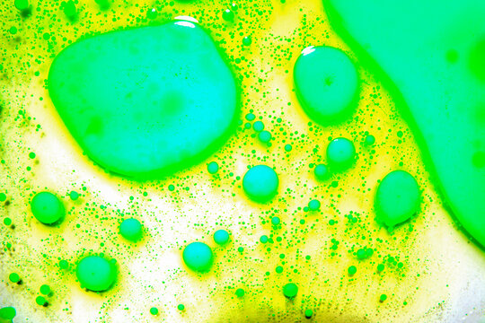 Abstract oil bubble spheres background in neon green tones