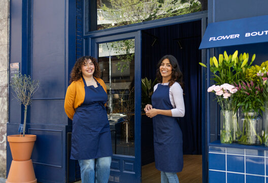 Florist shop front with friendly staff in blue aprons