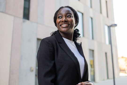 Smiling African businesswoman in city street portrait