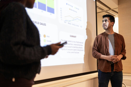 Coworking team presenting sales dashboard during office meeting