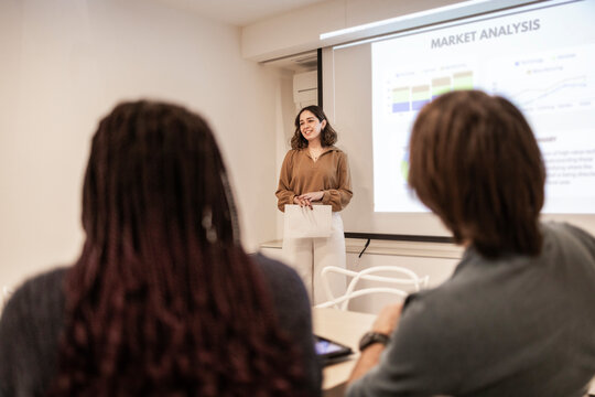 Coworking team meeting with presentation in modern office