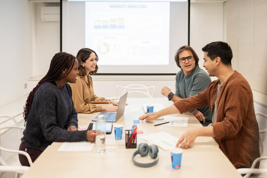 Diverse coworking team meeting in modern office workspace