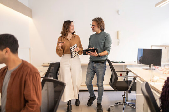 Coworking team discussing project in modern open office