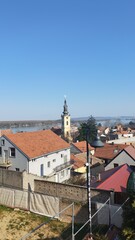 Fototapeta premium Elevated view of a city and river from a high vantage point. Urban landscape combining water, buildings, and surrounding environment in a wide panoramic scene.
