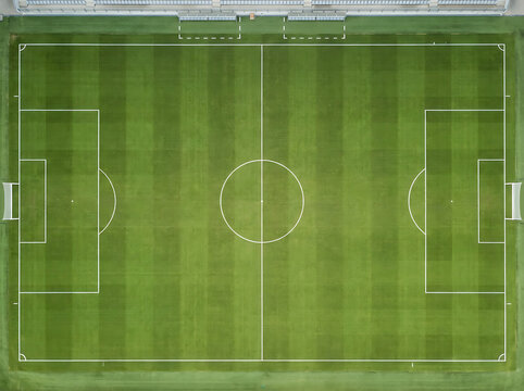 Aerial view of a green soccer field with white lines