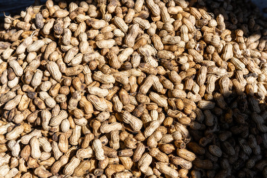 Peanuts in their shells are piled together at a market in Fianarantsoa