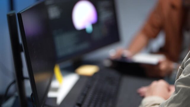 Close up of a technology developer hand pointing a stylus at a computer screen to debug machine learning scripts and artificial intelligence logic.