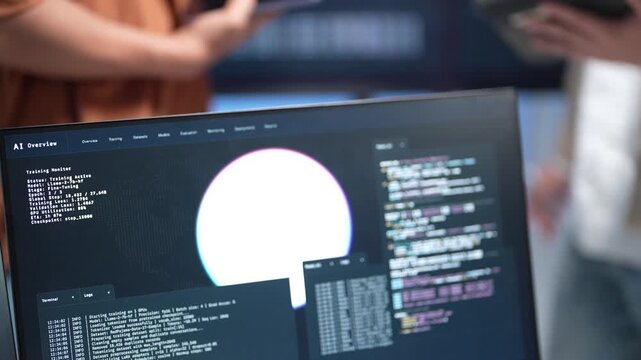 Close up view of a desktop computer screen displaying complex software database coding lines and a digital interface layout during a tech startup session.