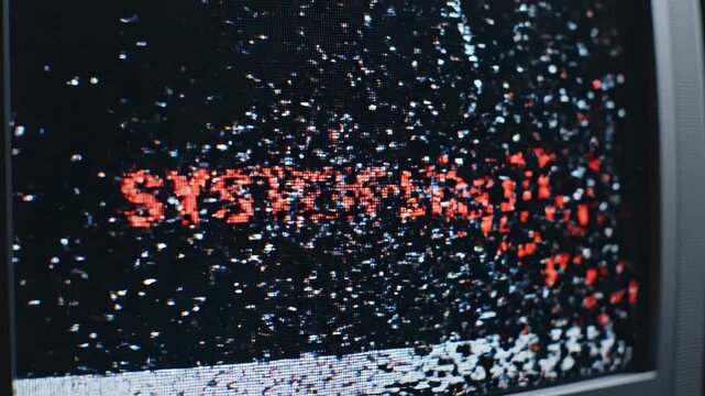 Distorted digital display screen with fragmented red text conveying a system failure warning, hinting at data corruption or technological malfunction within a corrupted electronic device