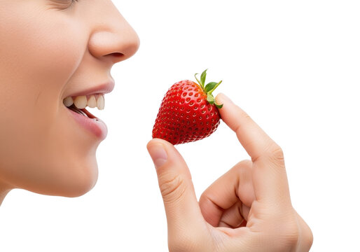 Close up of a woman holding a fresh strawberry isolated on transparent background