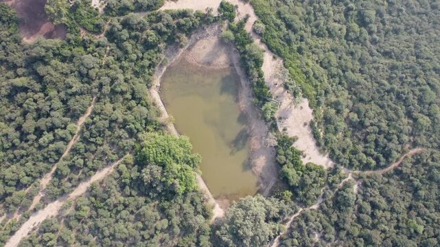 Tilla jogian water pond in dense jungle opens to wide panoramic forest scenery Pakistan