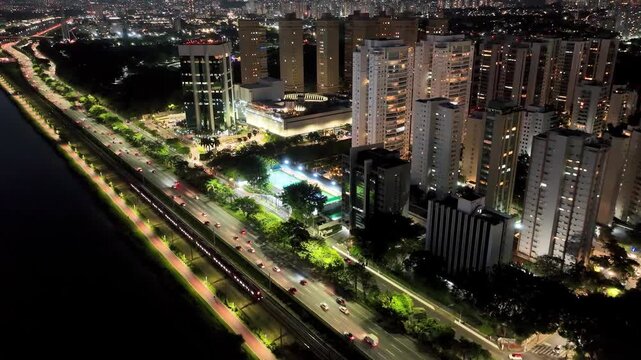 SAO PAULO, BRAZIL - MAY 2026: Aerial view of the Octavio Frias de Oliveira cable-stayed bridge and Marginal Pinheiros highway with river reflection.