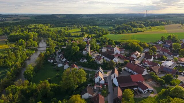 Drone aerial of Inkofen village in Freising district, Germany, capturing Schloss Inkofen, Catholic church and scenic Bavarian summer landscape.
