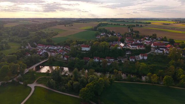 Panoramic drone shot of Inkofen in Freising district, Germany, showing the historic center, Amper bridge and scenic Bavarian countryside landscape.