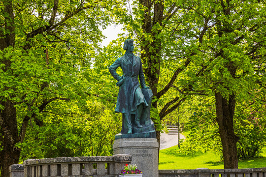 Close-up view of Dag Hammarskjold monument surrounded by green park and trees. Sweden. Uppsala. 