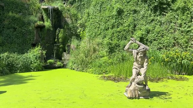 Kinsky Park in Prague. Statue of a Titan in a Pond