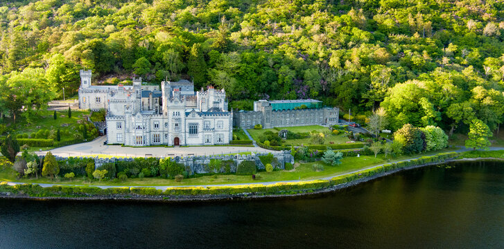 Aerial view of Kylemore Abbey on Pollacappul Lough in Connemara, County Galway, Ireland. Historic neo Gothic abbey and lakeside estate in a wooded mountain landscape.