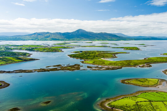 Morning aerial view of the islands of Clew Bay in County Mayo, Ireland, with calm blue water and vivid green shores. A serene coastal landscape on Irelands west coast.