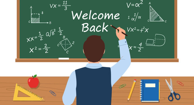 Male teacher writing welcome back message on green chalkboard.
