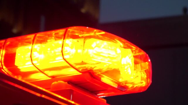 JAPAN : Close up view of a fire truck flashing red emergency lights and siren responding to a rescue mission. Fire engine public safety vehicle detail. Slow motion shot.