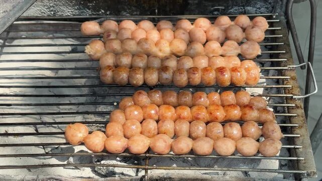 Thai Street Food Sausage Balls Cooking over Hot Coals